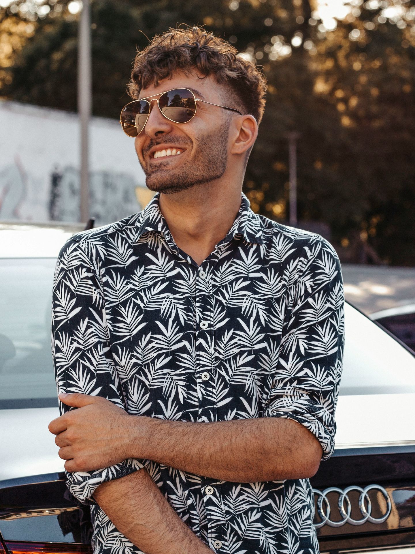 man in black and white floral button up shirt wearing black framed eyeglasses